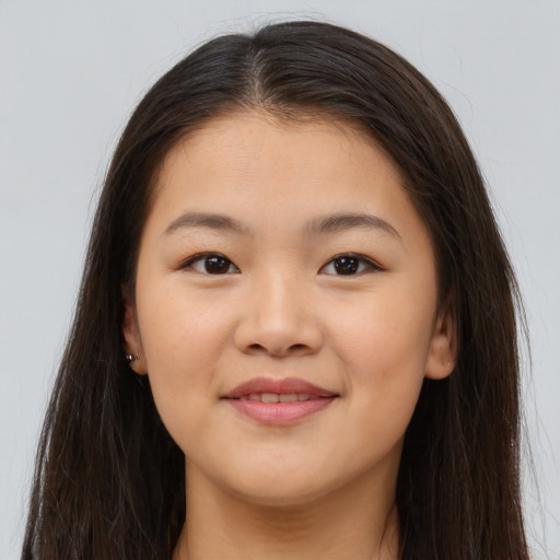 Joyful asian young-adult female with long  brown hair and brown eyes