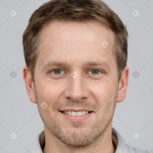 Joyful white adult male with short  brown hair and brown eyes