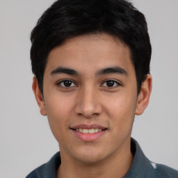 Joyful asian young-adult male with short  black hair and brown eyes