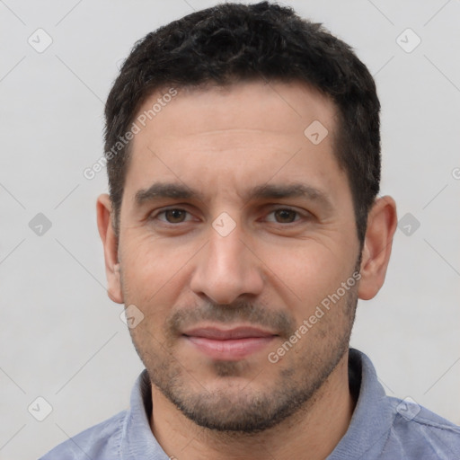 Joyful white young-adult male with short  black hair and brown eyes