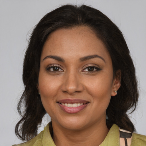 Joyful black young-adult female with medium  brown hair and brown eyes