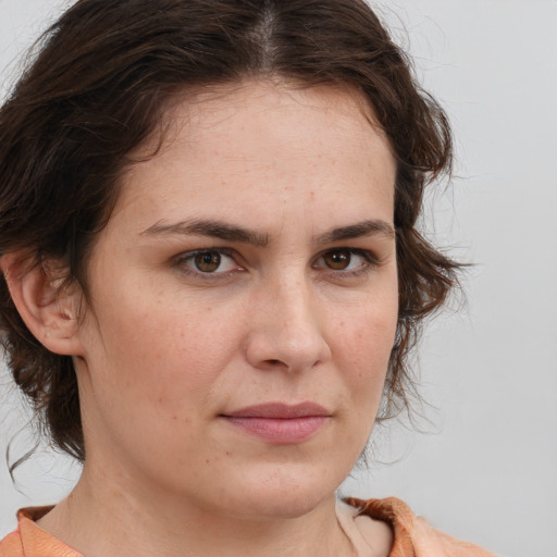 Joyful white adult female with medium  brown hair and brown eyes