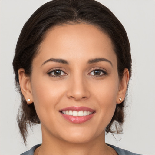 Joyful white young-adult female with medium  brown hair and brown eyes