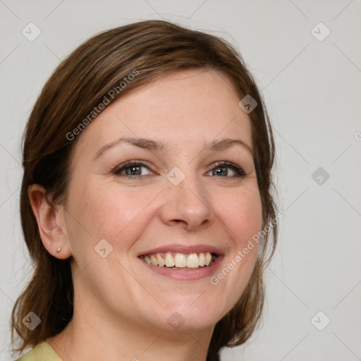 Joyful white young-adult female with medium  brown hair and blue eyes