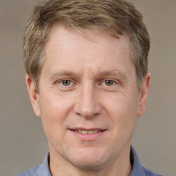 Joyful white adult male with short  brown hair and grey eyes