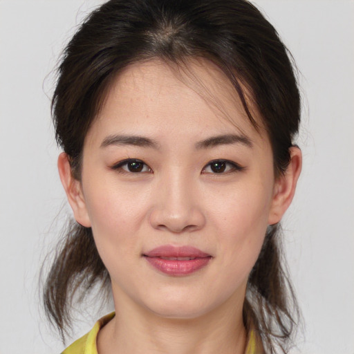 Joyful white young-adult female with medium  brown hair and brown eyes