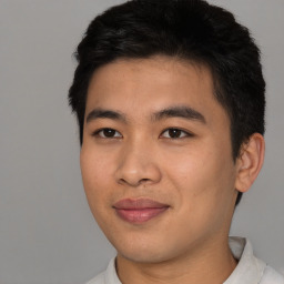 Joyful asian young-adult male with short  black hair and brown eyes