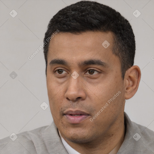 Neutral latino young-adult male with short  black hair and brown eyes