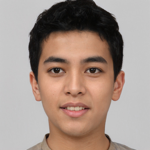 Joyful asian young-adult male with short  black hair and brown eyes