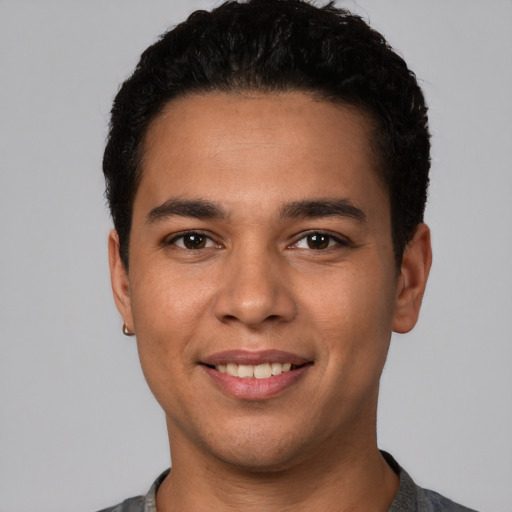 Joyful white young-adult male with short  black hair and brown eyes