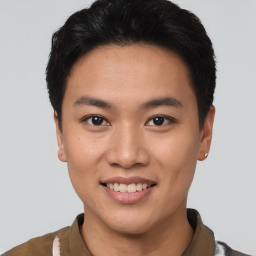Joyful asian young-adult male with short  brown hair and brown eyes