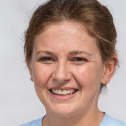 Joyful white adult female with medium  brown hair and grey eyes