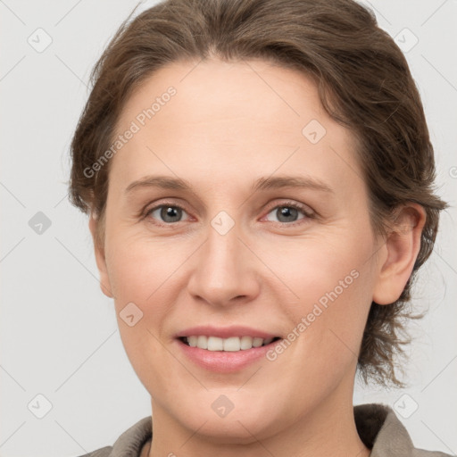 Joyful white young-adult female with medium  brown hair and grey eyes