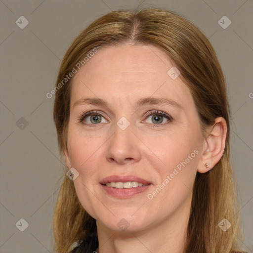 Joyful white adult female with long  brown hair and grey eyes