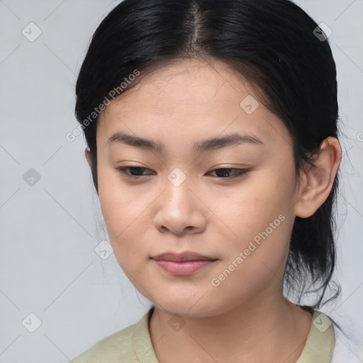 Joyful asian young-adult female with medium  black hair and brown eyes