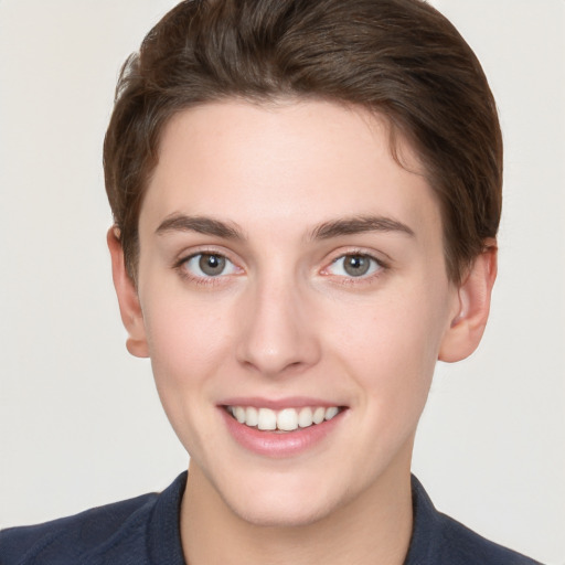 Joyful white young-adult female with short  brown hair and grey eyes