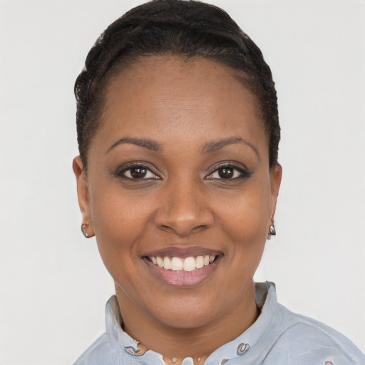 Joyful black young-adult female with short  black hair and brown eyes