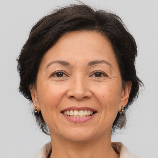 Joyful white adult female with medium  brown hair and brown eyes