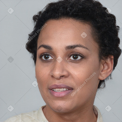 Joyful black young-adult female with short  brown hair and brown eyes