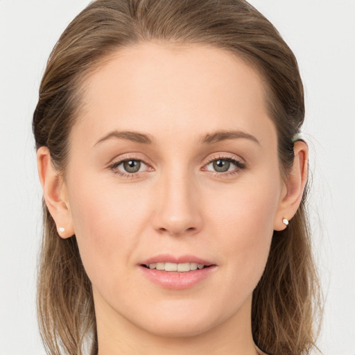 Joyful white young-adult female with long  brown hair and blue eyes