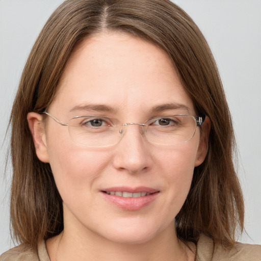 Joyful white adult female with medium  brown hair and grey eyes