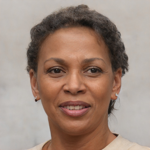 Joyful black adult female with short  brown hair and brown eyes