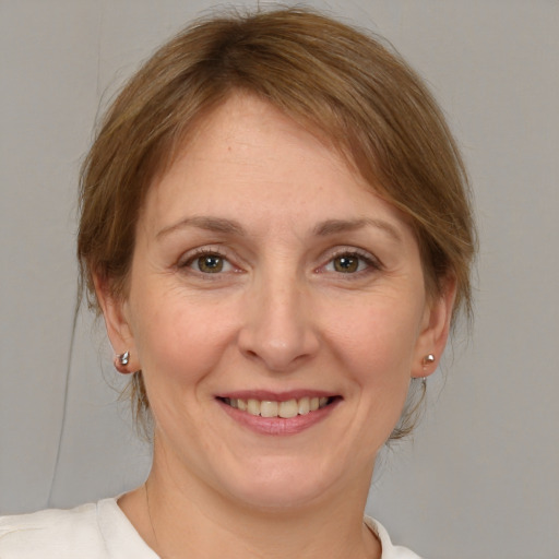 Joyful white adult female with medium  brown hair and brown eyes