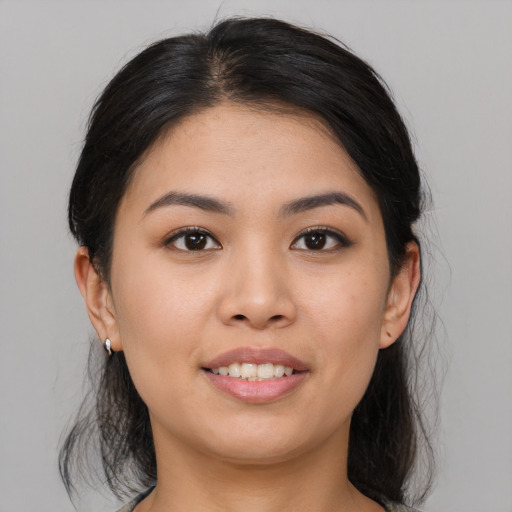 Joyful white young-adult female with medium  brown hair and brown eyes