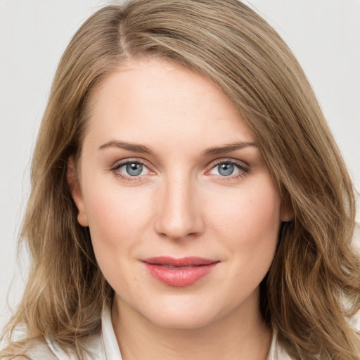 Joyful white young-adult female with medium  brown hair and green eyes