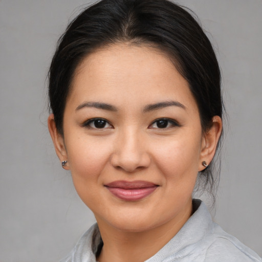 Joyful asian young-adult female with medium  brown hair and brown eyes