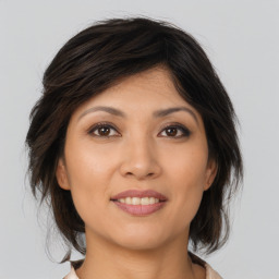 Joyful asian young-adult female with medium  brown hair and brown eyes