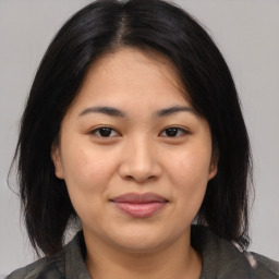 Joyful asian young-adult female with medium  black hair and brown eyes