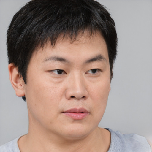 Neutral asian young-adult male with short  brown hair and brown eyes