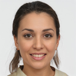 Joyful white young-adult female with medium  brown hair and brown eyes