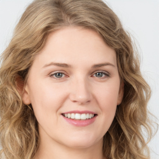 Joyful white young-adult female with long  brown hair and green eyes