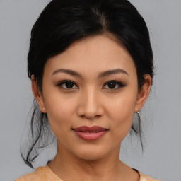 Joyful asian young-adult female with medium  black hair and brown eyes