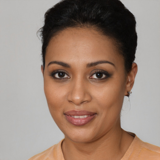 Joyful black young-adult female with short  black hair and brown eyes