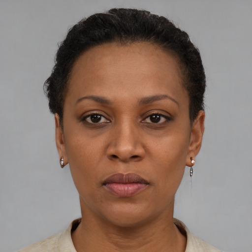 Joyful black adult female with short  brown hair and brown eyes