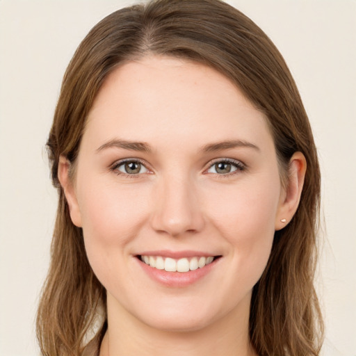 Joyful white young-adult female with long  brown hair and grey eyes