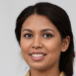 Joyful latino young-adult female with long  brown hair and brown eyes