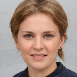 Joyful white young-adult female with medium  brown hair and blue eyes