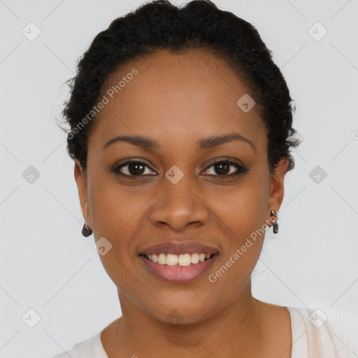 Joyful black young-adult female with short  black hair and brown eyes
