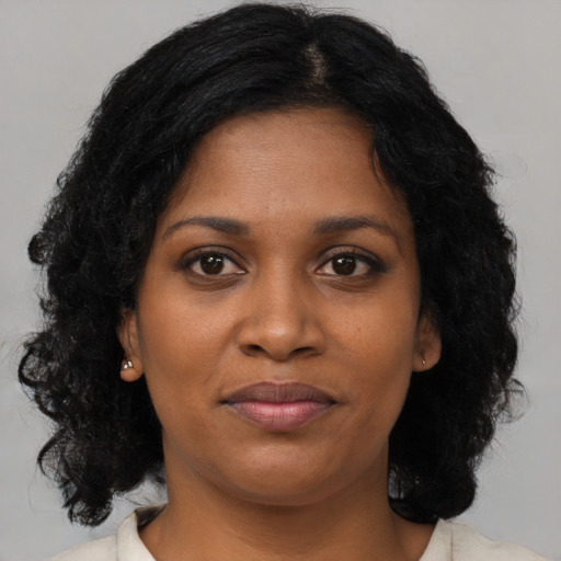 Joyful black young-adult female with medium  brown hair and brown eyes
