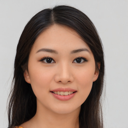 Joyful asian young-adult female with long  brown hair and brown eyes