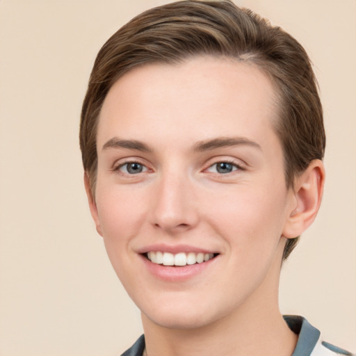 Joyful white young-adult female with short  brown hair and grey eyes