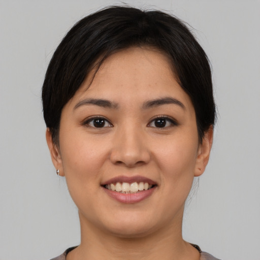 Joyful asian young-adult female with short  brown hair and brown eyes
