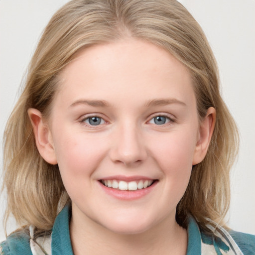 Joyful white young-adult female with medium  brown hair and blue eyes