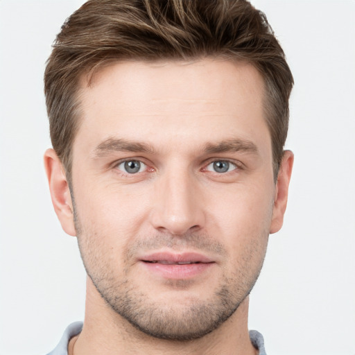 Joyful white young-adult male with short  brown hair and grey eyes