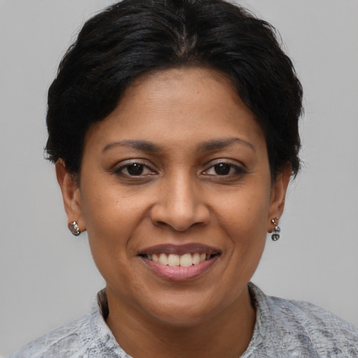 Joyful black adult female with short  brown hair and brown eyes