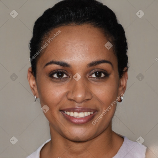 Joyful black young-adult female with short  black hair and brown eyes